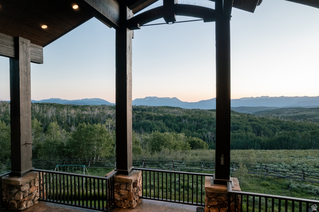 9156 Forest Road, Unit 24 Heber City, UT 84036 - Photo 14 of 42 Spacious covered deck featuring substantial timber columns with stone bases and metal railings