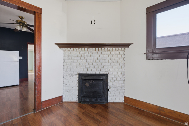 869 West Center Street Provo, UT 84601 - Photo 10 of 32 Detailed view of freestanding refrigerator, a ceiling fan, wood finished floors, and a fireplace