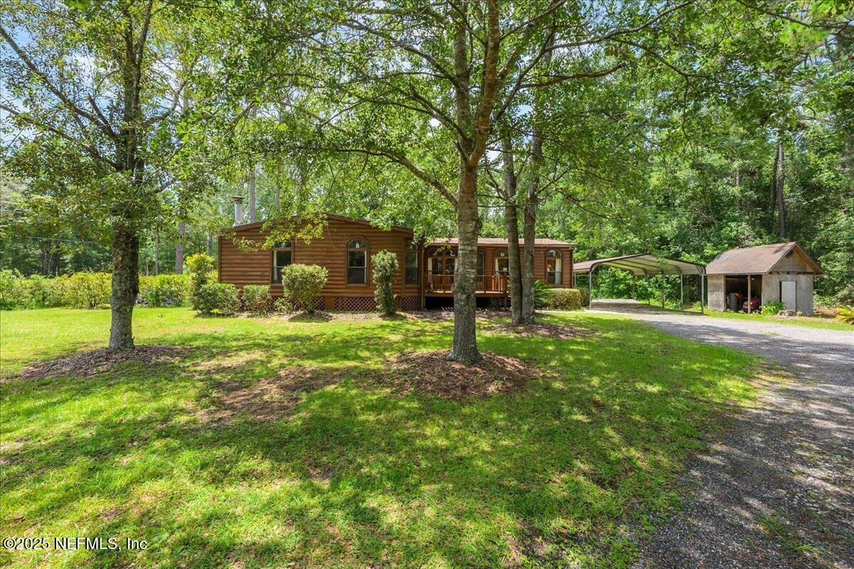 54451 Marsh Road Callahan, FL 32011 - Photo 1 of 26 a view of a house with a backyard