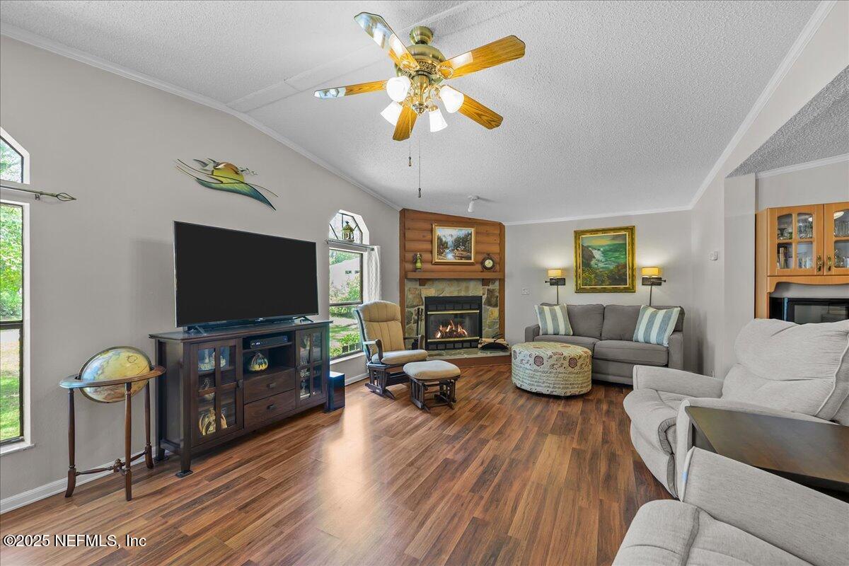 54451 Marsh Road Callahan, FL 32011 - Photo 11 of 26 a living room with furniture and a flat screen tv