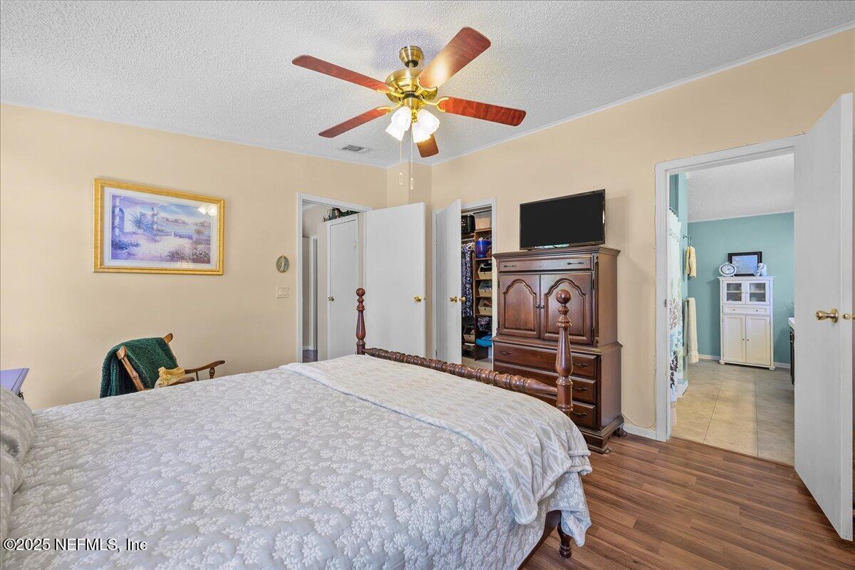 54451 Marsh Road Callahan, FL 32011 - Photo 13 of 26 a bedroom with a bed and a flat screen tv