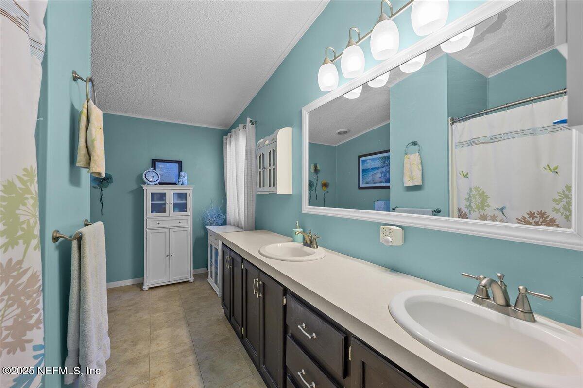54451 Marsh Road Callahan, FL 32011 - Photo 14 of 26 a bathroom with a double vanity sink and a mirror