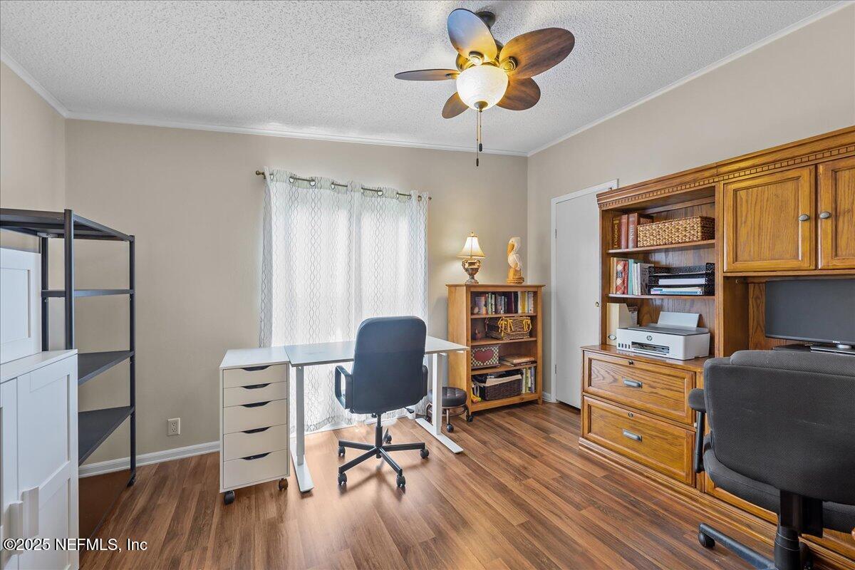 54451 Marsh Road Callahan, FL 32011 - Photo 15 of 26 a view of a workspace with furniture and wooden floor