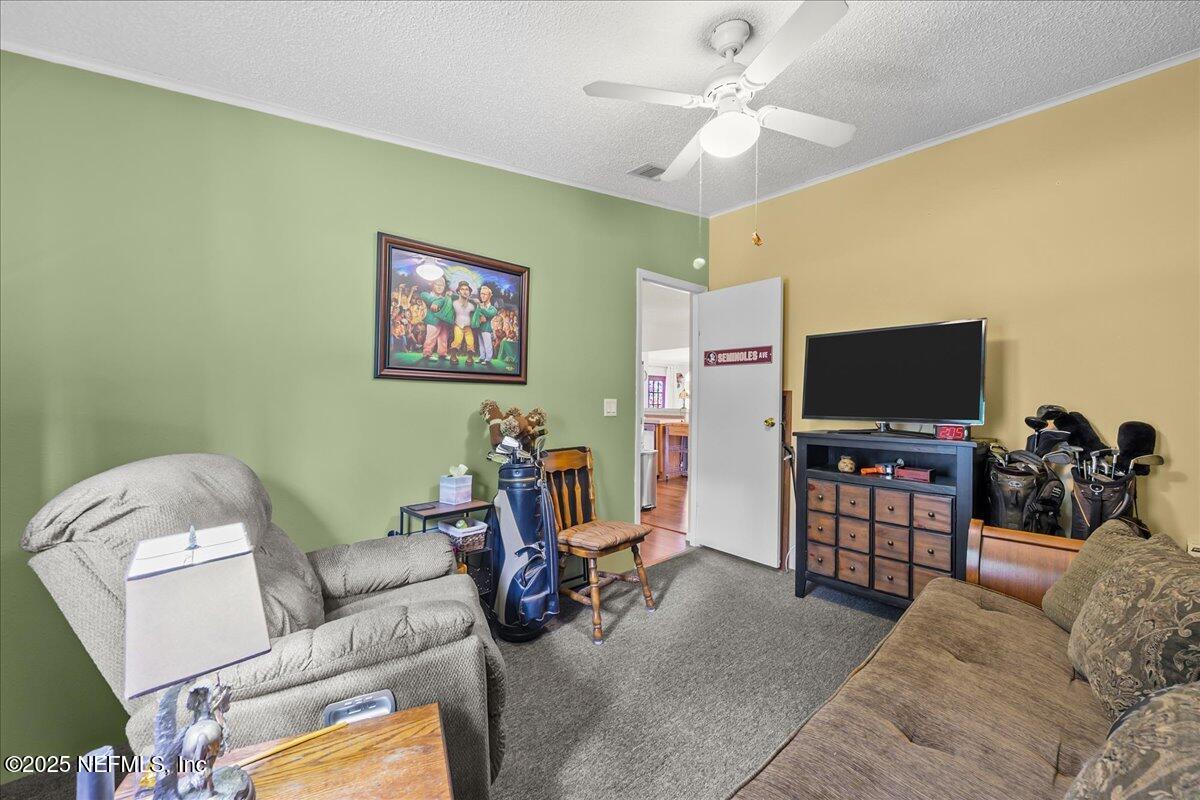54451 Marsh Road Callahan, FL 32011 - Photo 17 of 26 a living room with furniture and a flat screen tv