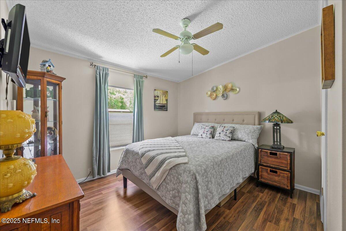54451 Marsh Road Callahan, FL 32011 - Photo 19 of 26 a bedroom with a bed a couch and a window