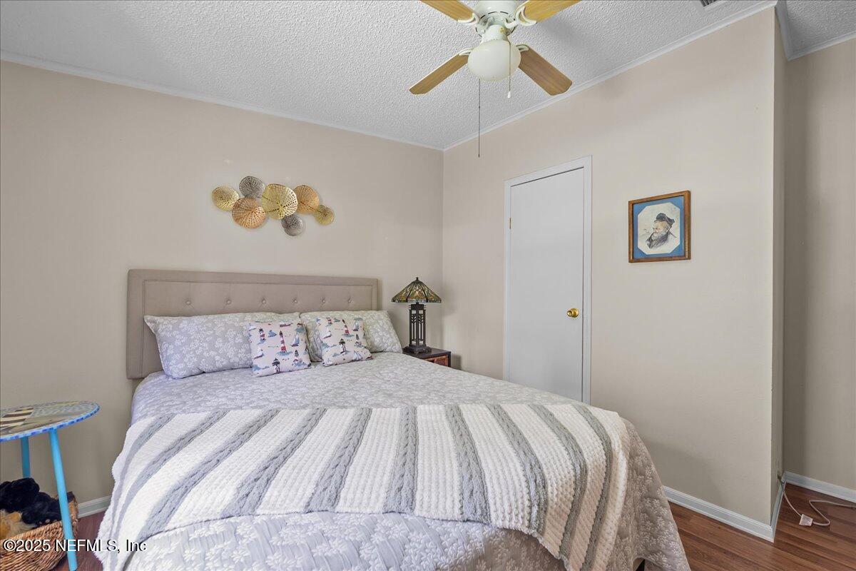 54451 Marsh Road Callahan, FL 32011 - Photo 20 of 26 a bedroom with a large bed and a chandelier