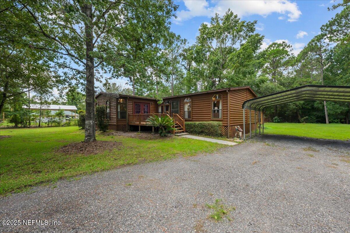 54451 Marsh Road Callahan, FL 32011 - Photo 2 of 26 a view of a house with backyard and trees