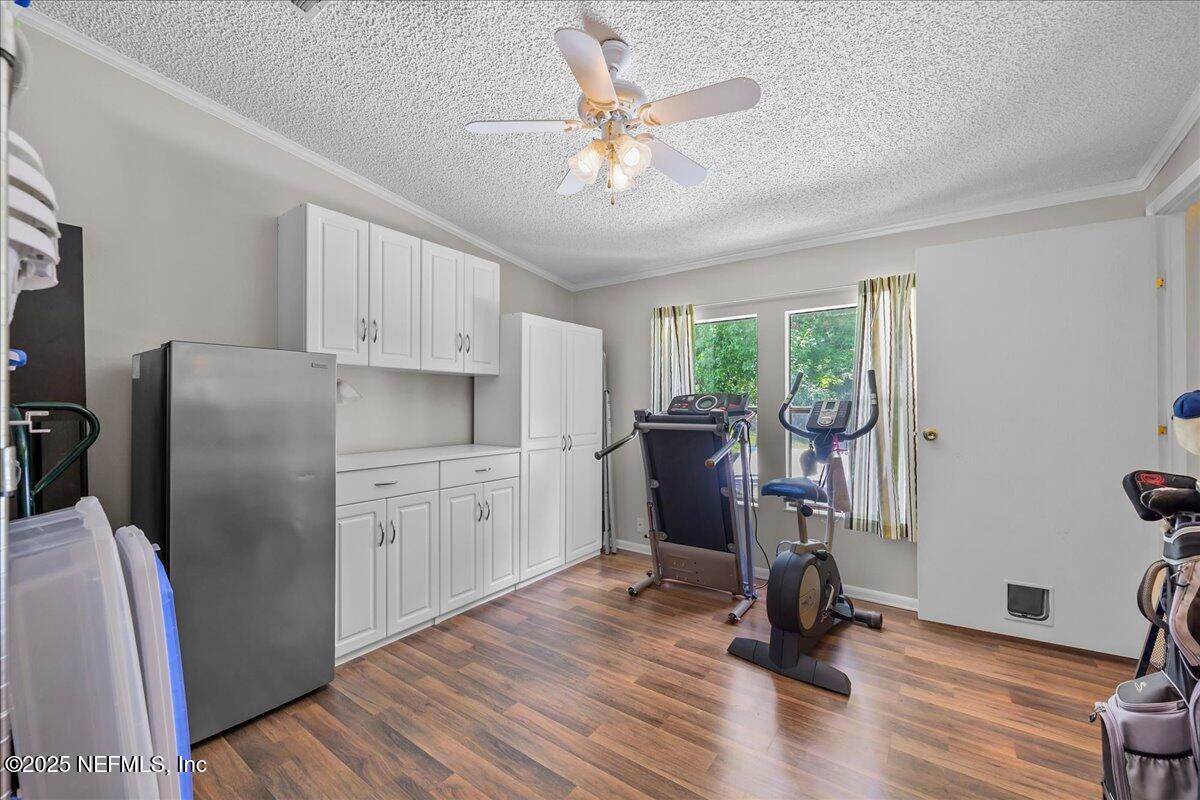 54451 Marsh Road Callahan, FL 32011 - Photo 21 of 26 a kitchen with a refrigerator cabinets and wooden floor