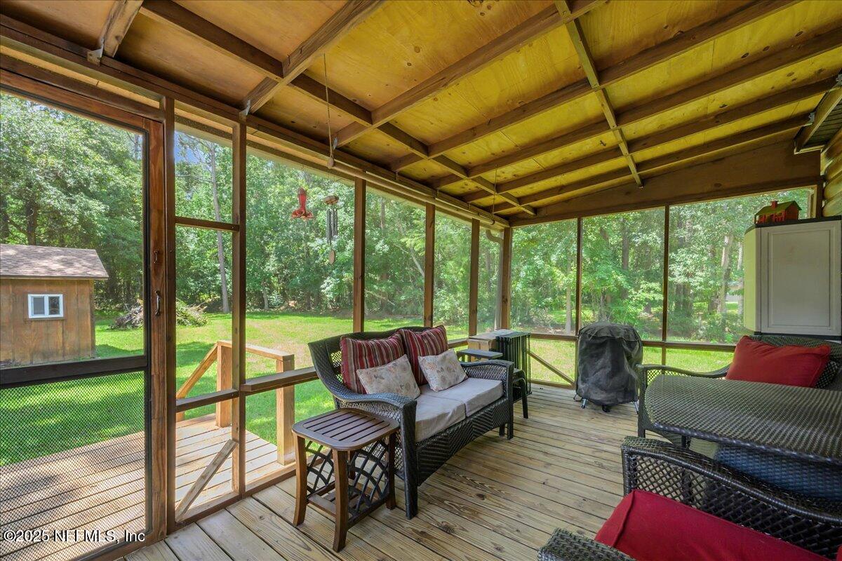 54451 Marsh Road Callahan, FL 32011 - Photo 23 of 26 a living room with furniture and a floor to ceiling window
