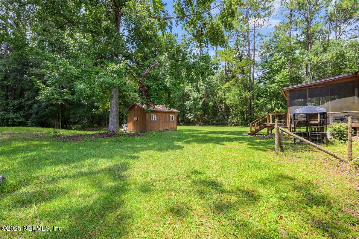 54451 Marsh Road Callahan, FL 32011 - Photo 24 of 26 a backyard of a house with table and chairs