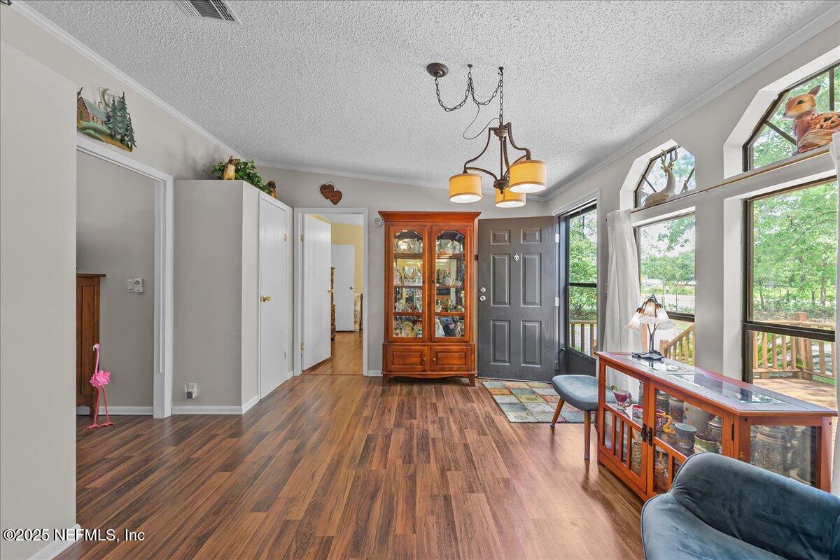 54451 Marsh Road Callahan, FL 32011 - Photo 5 of 26 a very nice looking room with a large window and wooden floor