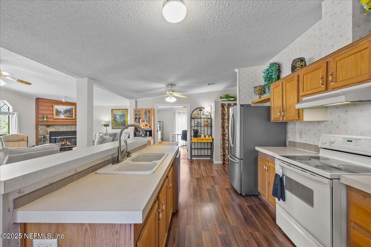 54451 Marsh Road Callahan, FL 32011 - Photo 6 of 26 a kitchen with sink stove and refrigerator