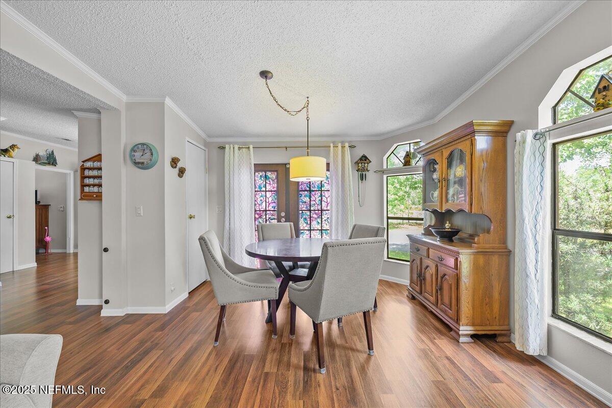 54451 Marsh Road Callahan, FL 32011 - Photo 10 of 26 a view of a dining room with furniture window and wooden floor
