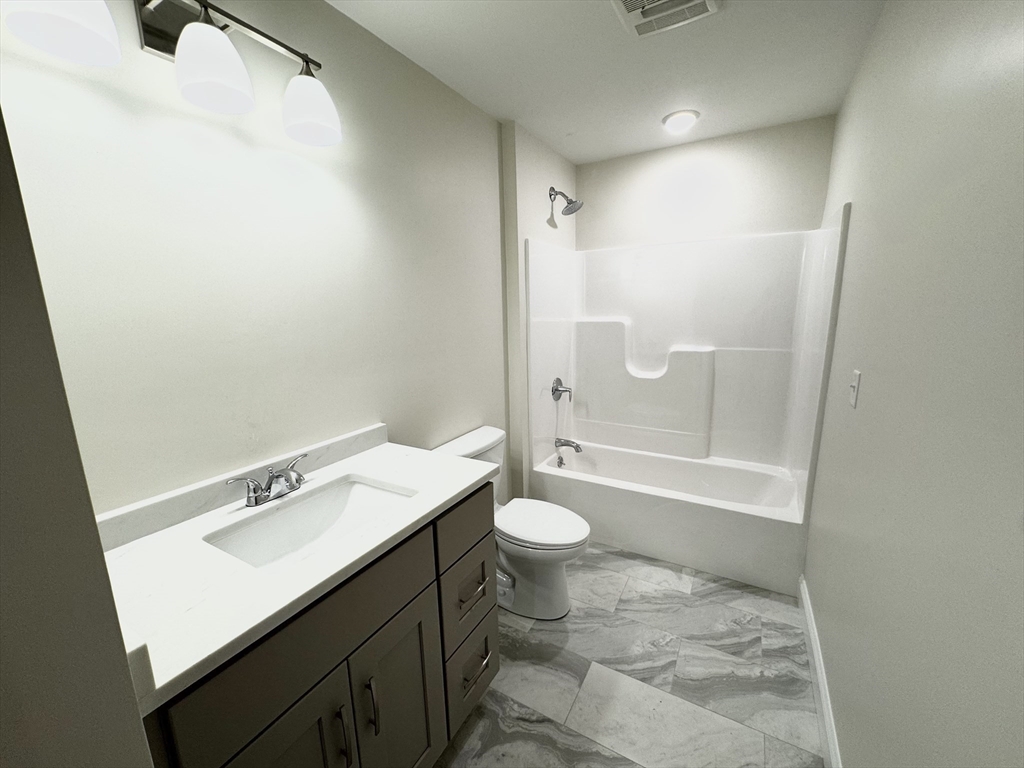 78 Arlington Street, Unit 2 Taunton, MA 02780 - Photo 22 of 28 a bathroom with a sink a toilet and shower