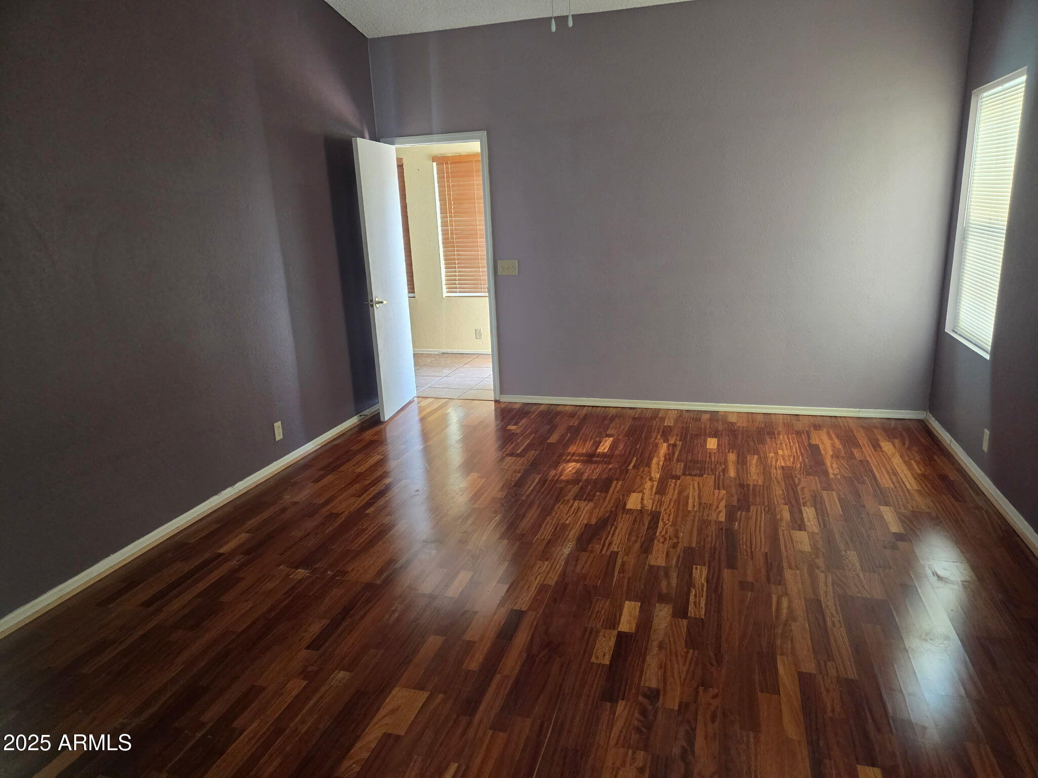 3009 East Utopia Road Phoenix, AZ 85050 - Photo 4 of 13 a view of an empty room and wooden floor