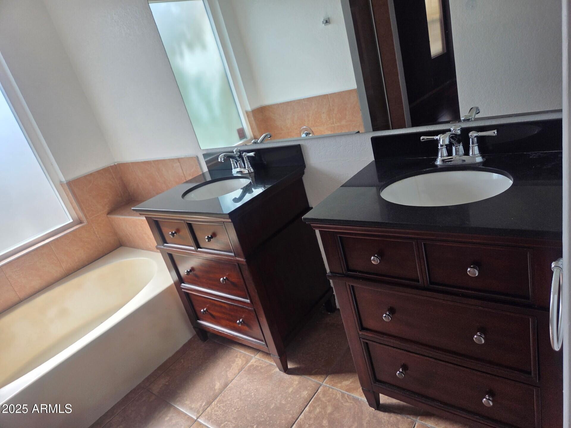 3009 East Utopia Road Phoenix, AZ 85050 - Photo 5 of 13 a bathroom with a sink vanity granite tub and mirror