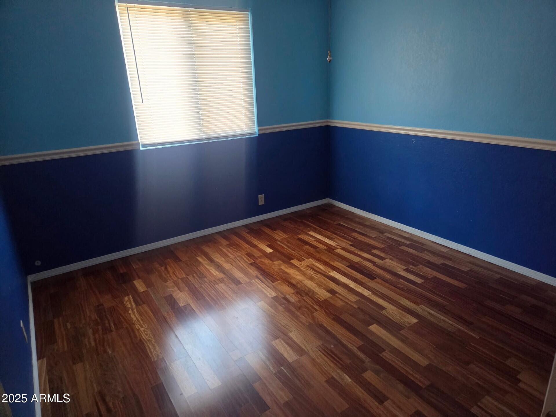 3009 East Utopia Road Phoenix, AZ 85050 - Photo 6 of 13 a view of empty room with wooden floor and fan