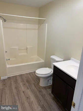 a bathroom with a toilet a sink and shower