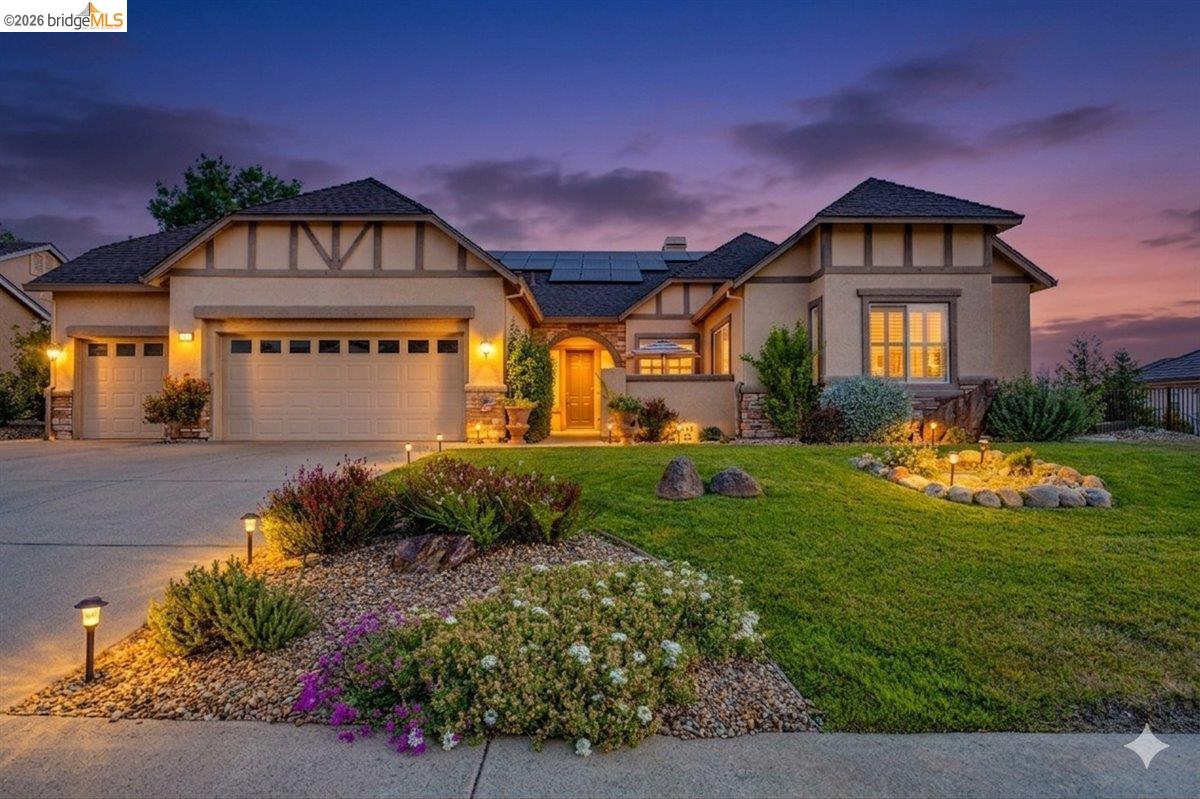 158 Rock Ridge Lane Copperopolis, CA 95228 - Photo 2 of 72 Stucco exterior featuring decorative timber framing, multiple gables, and a prominent front entry with a wood-finish door