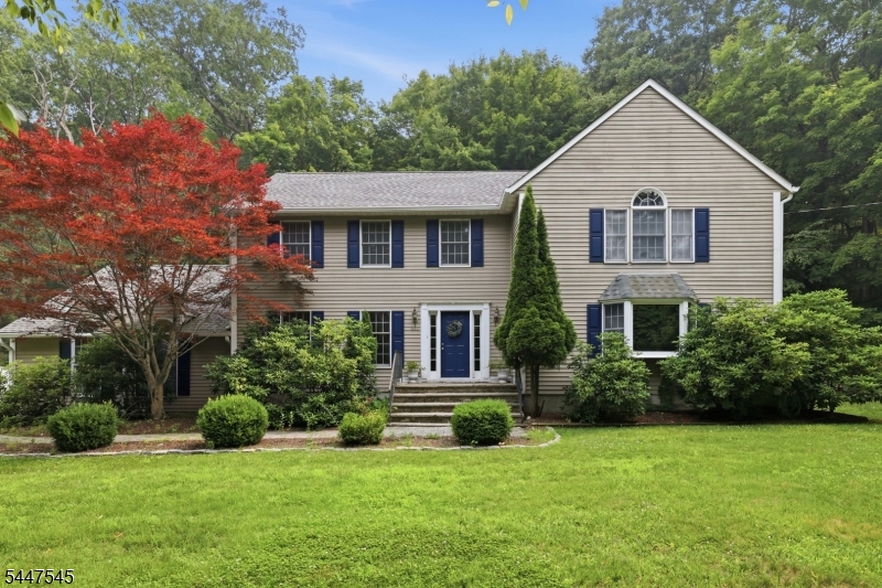 860 Glen Road Sparta, NJ 07871 - Photo 1 of 43 a view of a yard in front of a house with plants and large tree