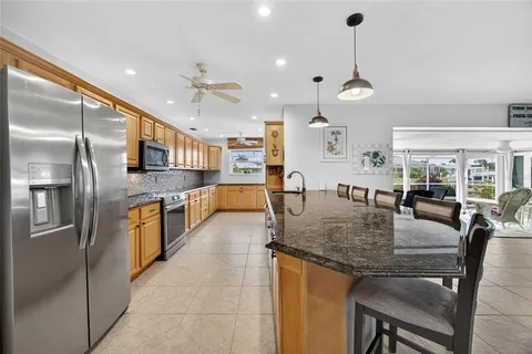 a large kitchen with stainless steel appliances granite countertop a stove and refrigerator