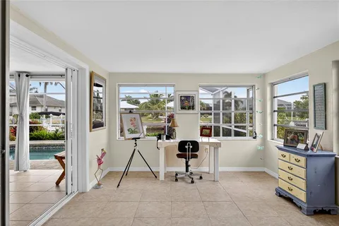 a view of a livingroom with workspace and a window