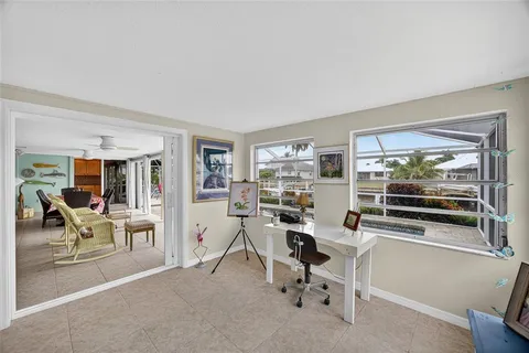 a work room with furniture and a flat screen tv