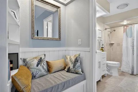 a living room with furniture and a toilet