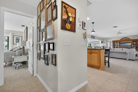 a view of a hallway with workspace and living room