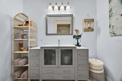 a bathroom with a toilet sink and mirror