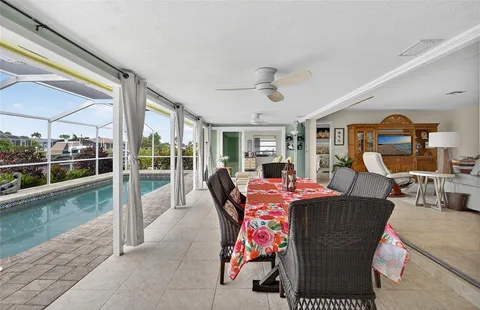 a dining room with furniture and a floor to ceiling window
