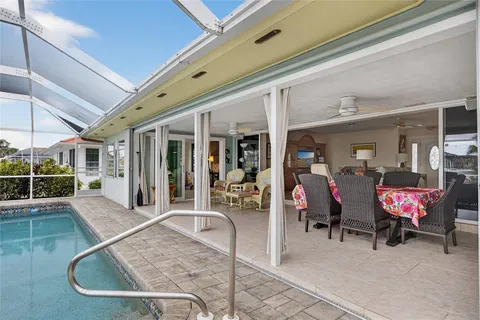 a view of a patio with table and chairs