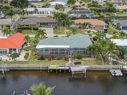 a view of a swimming pool with lawn chairs under an umbrella