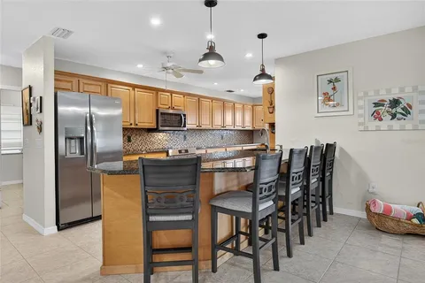 a kitchen with kitchen island a counter top space appliances and cabinets