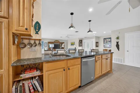 a kitchen with stainless steel appliances granite countertop a sink and cabinets