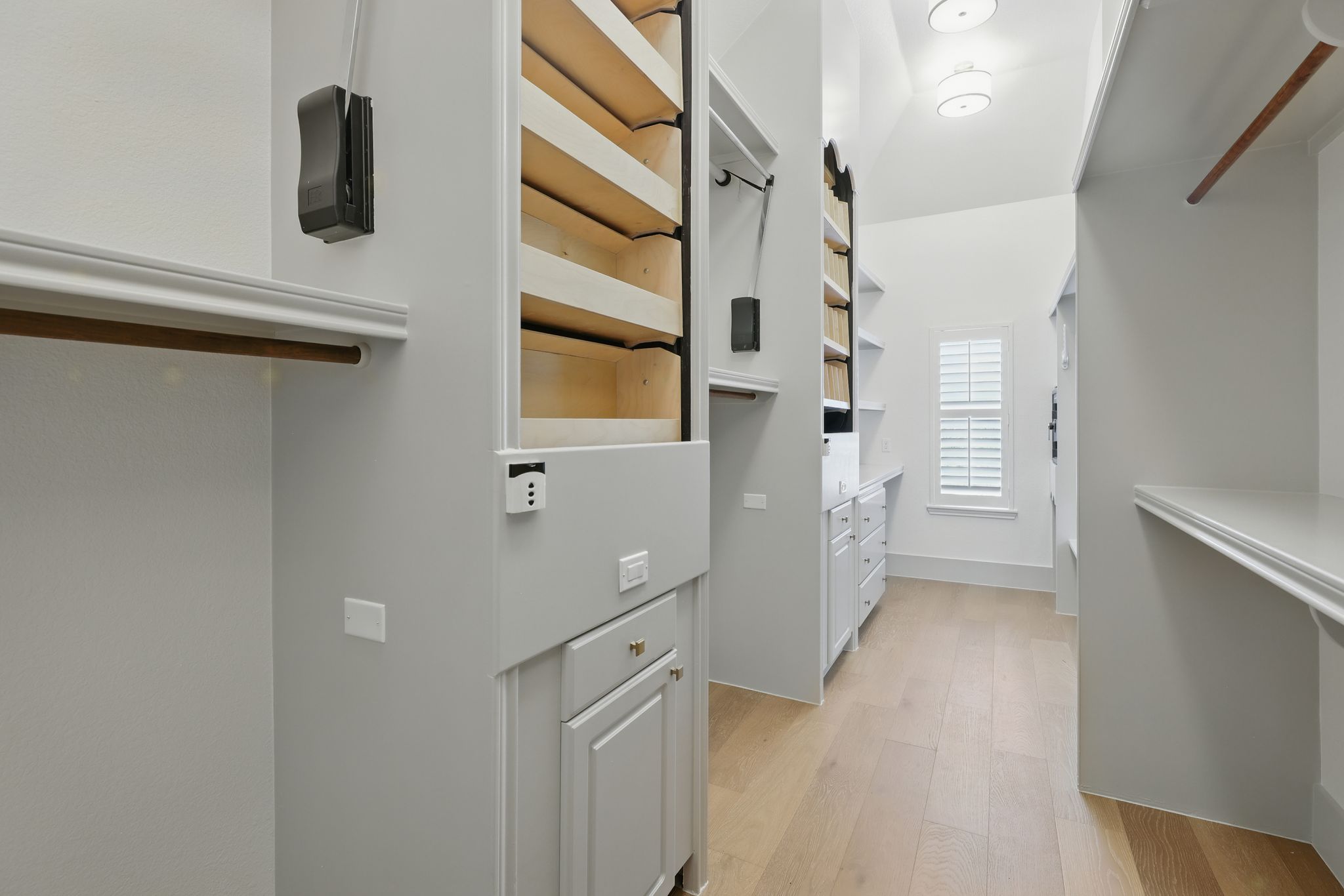 6905 Rudi Cove Austin, TX 78759 - Photo 28 of 36 Spacious closet with Motorized Revolving Shoe & Purse Bins plus Auto-Lowering Hanging Racks.