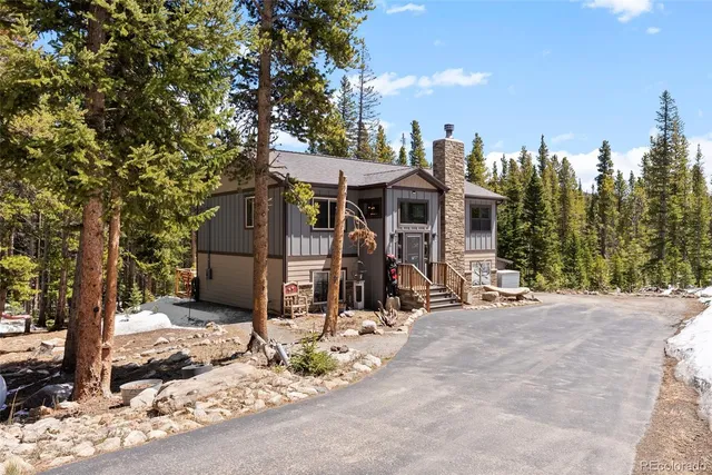 a view of a park with trees and a house in the background