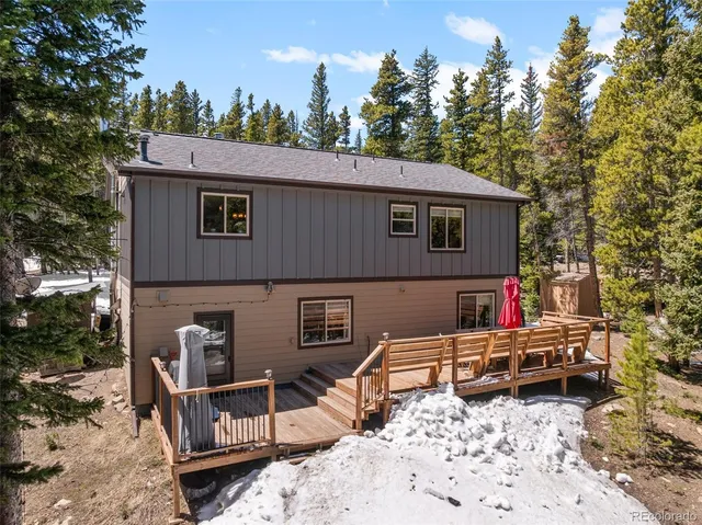 a house view with a sitting space fire pit and outdoor space