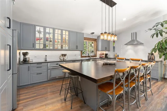 a kitchen with center island table and chairs in it