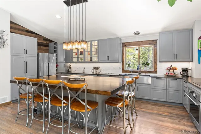 a kitchen with a table chairs sink and cabinets