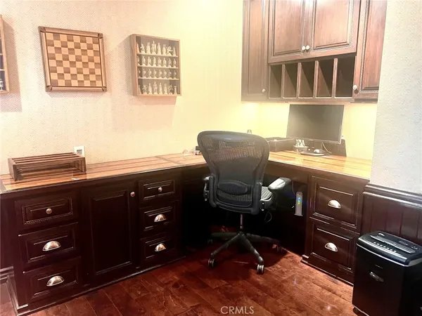 a view of workspace with wooden wall cabinetry and piano