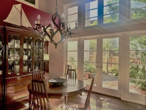 a view of a dining room with furniture large windows and wooden floor