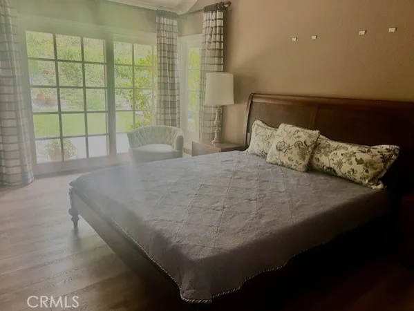 a bed sitting in a bedroom next to a window