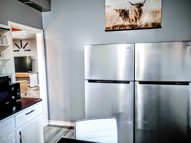 a view of a bedroom with a refrigerator and a sink