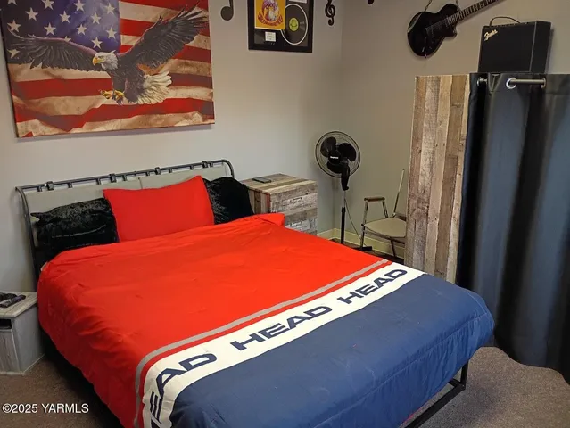 a blue bed sitting in a bedroom and mirror