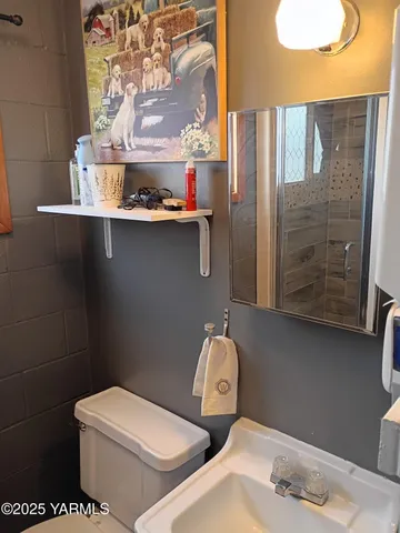 a bathroom with a toilet sink and shower