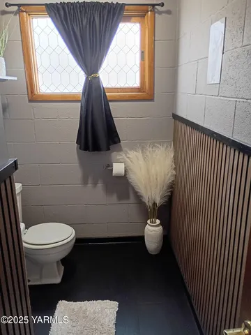 a bathroom with a sink toilet and window