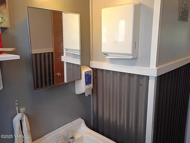 a bathroom with a window and a mirror