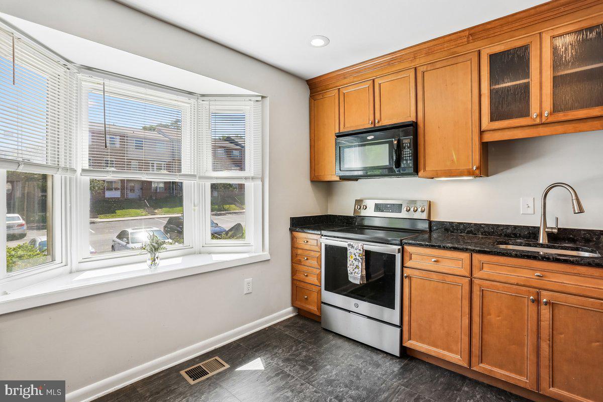 76 Timber Rock Road Gaithersburg, MD 20878 - Photo 18 of 51 a kitchen with stainless steel appliances granite countertop a stove and a sink