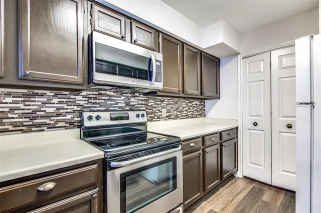 a kitchen with a stove and a microwave